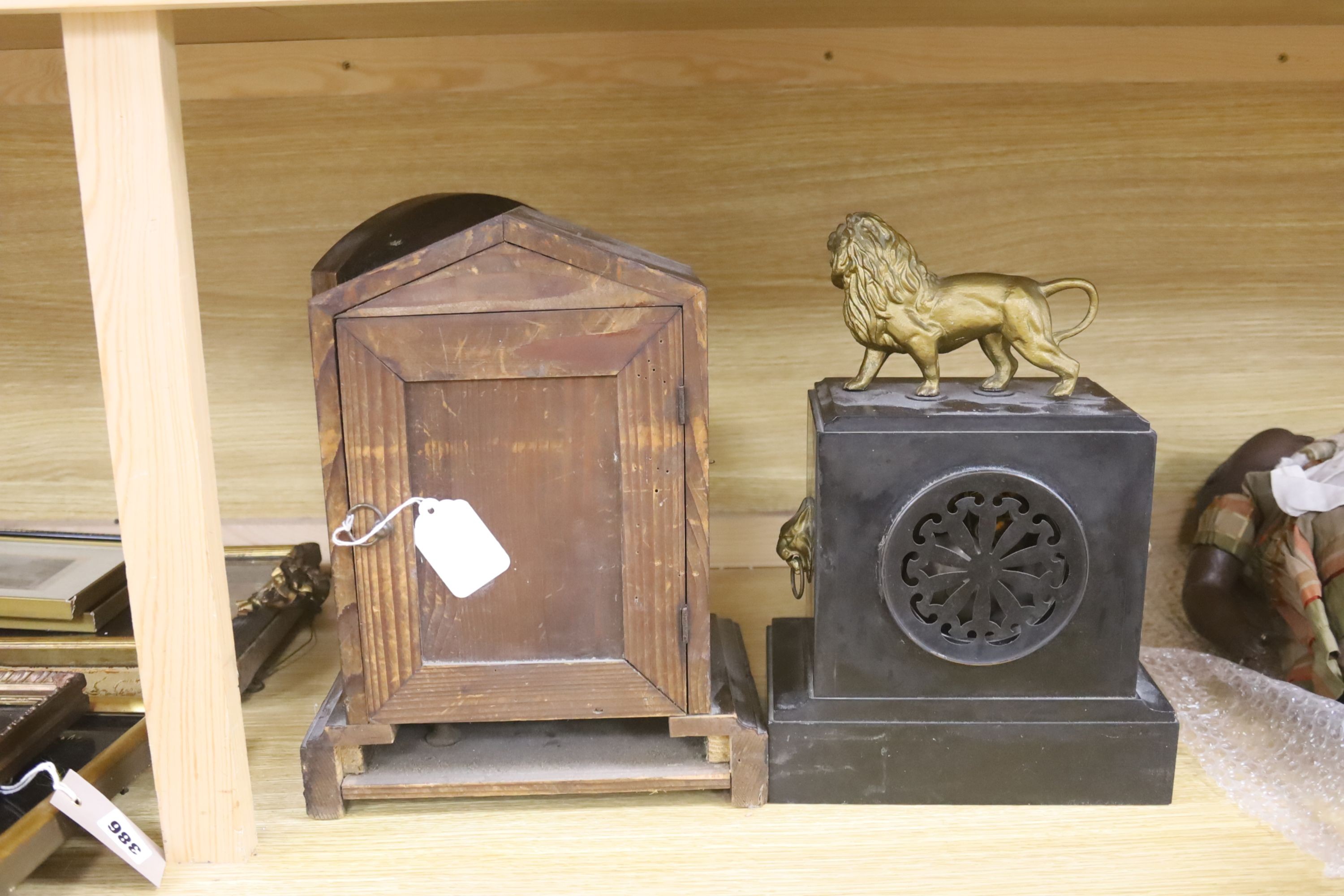 A slate mantel clock with lion surmount and a mahogany mantel clock